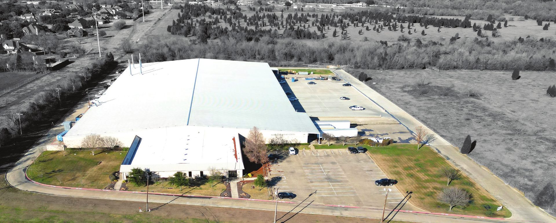 325 US Highway 80 — oblique aerial, full building massing